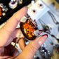 Hand-Carved Natural Baltic Amber Cameo Necklace with Rubies and White Sapphires